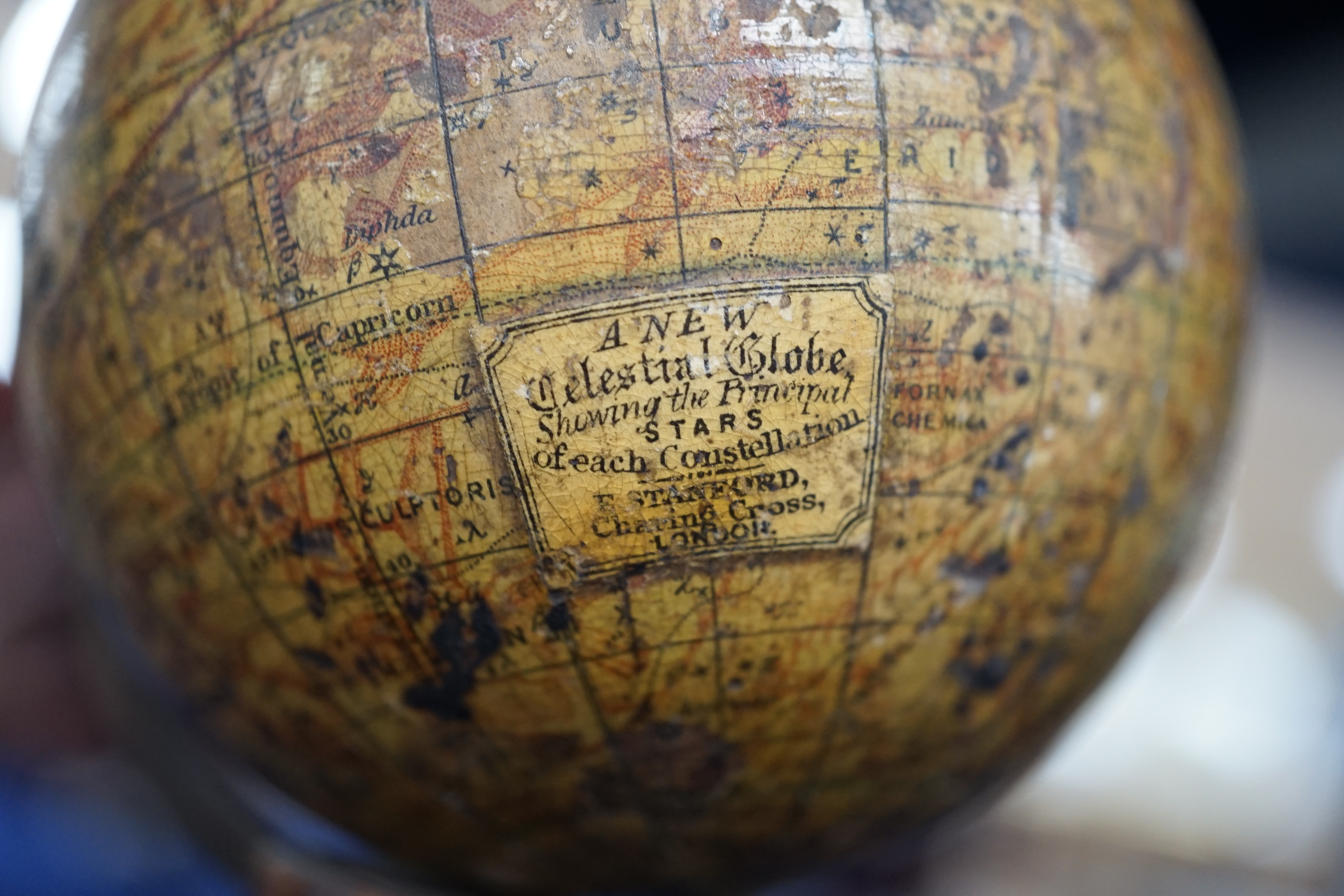 A 19th century 3 inch Stanford celestial globe, the makers panel reads; ‘A new celestial globe showing the principal stars of each Constellation E. Stanford Charing Cross, London’, diameter 7cm, on a turned mahogany stan